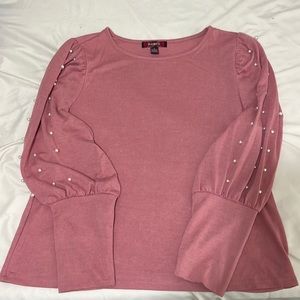 Very soft dusty rose sweater with pearl embellishments on the sleeves.